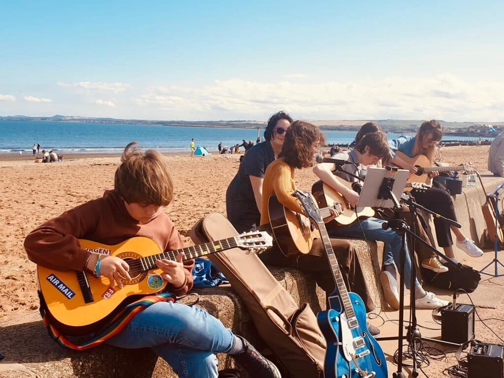 Guitar Lessons Edinburgh - playing guitar at Portobello Beach
